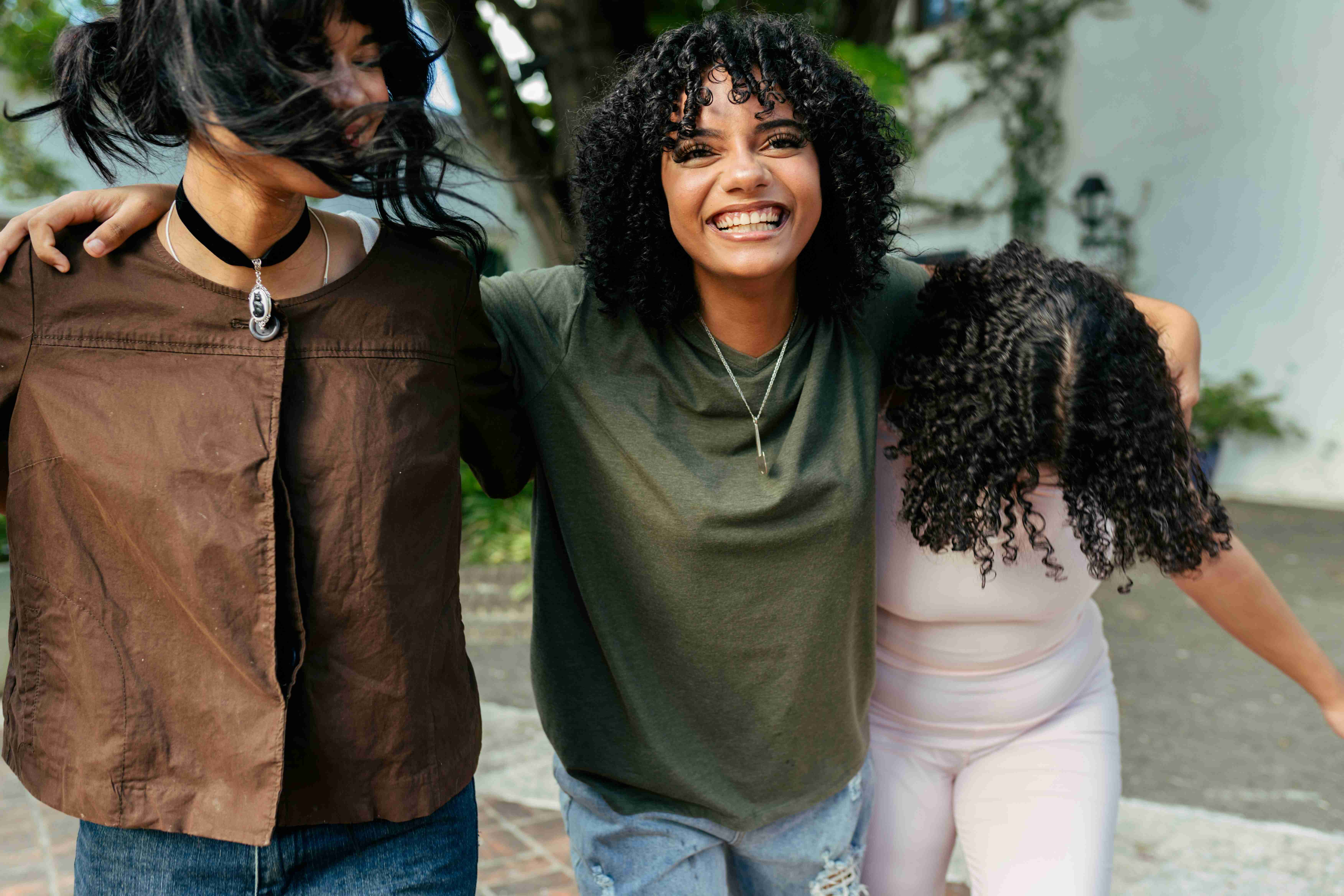 Three friends walking together outdoors
